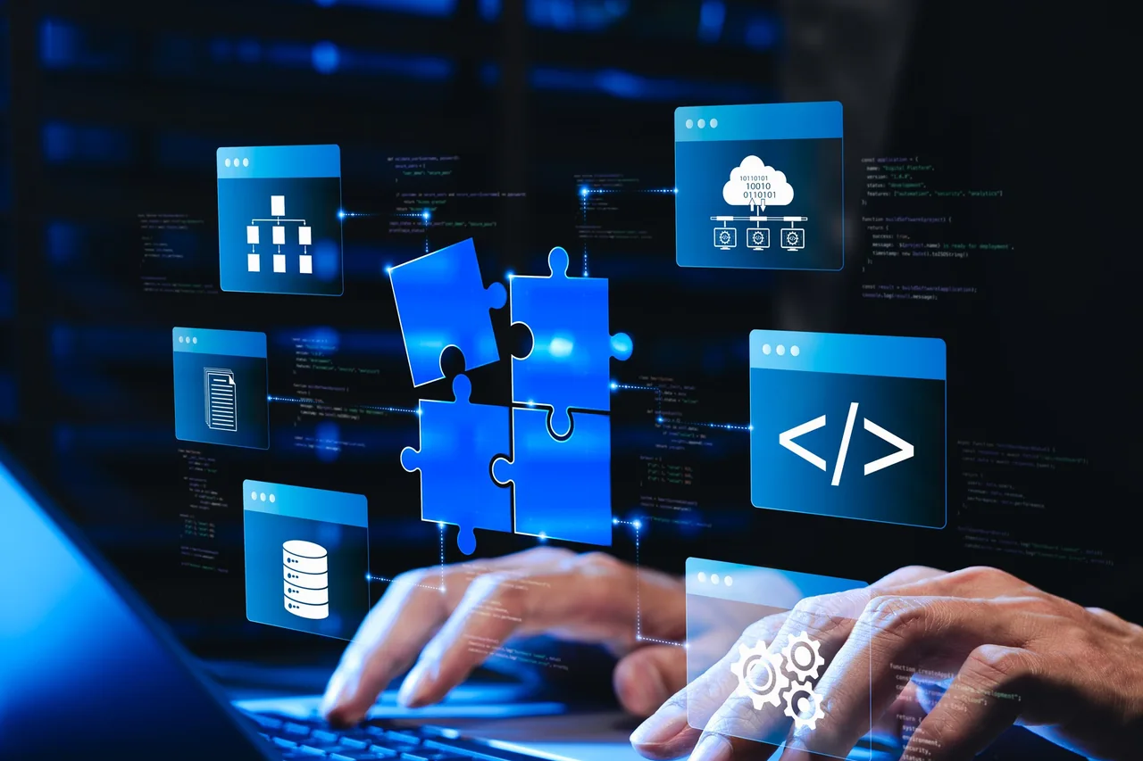 Hands using a laptop beneath blue interface, database, cloud, and code symbols