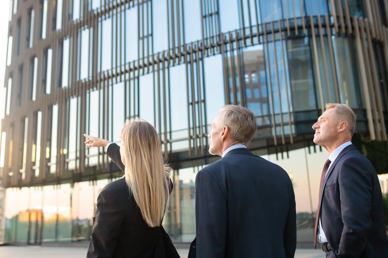 Commercial real estate professionals touring a modern office building