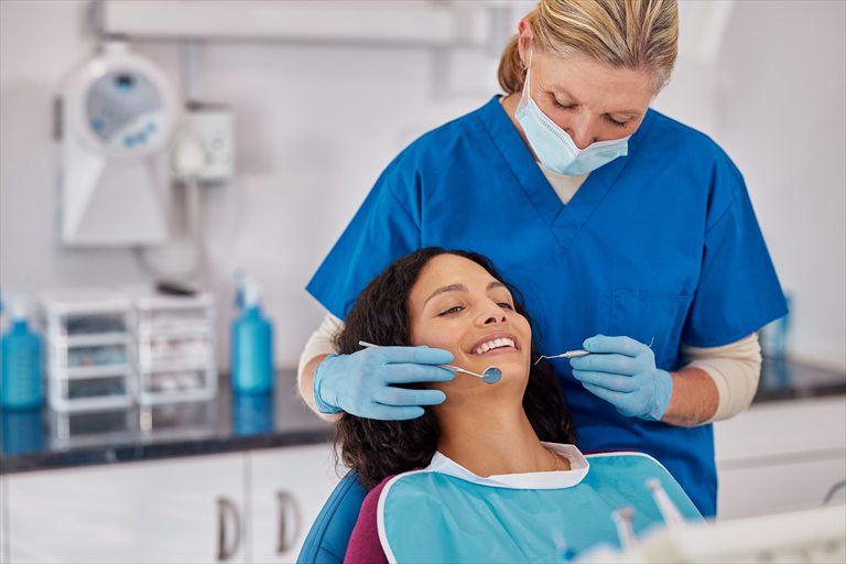 Dental professional examining a patient