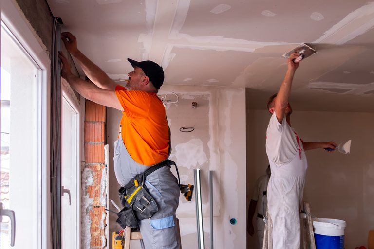 Construction workers finishing the interior of a new home