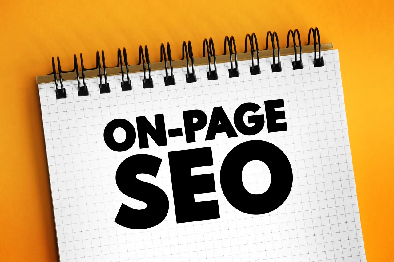 Spiral notebook labelled On-Page SEO on an orange surface