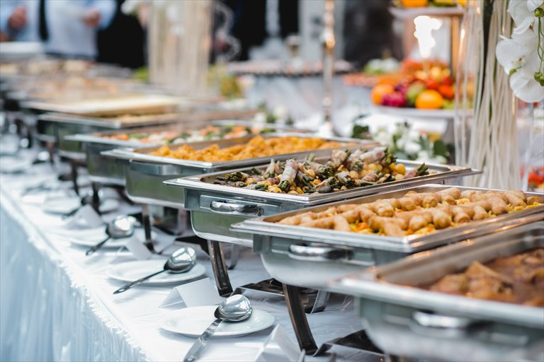 Buffet line with chafing dishes prepared for catering service