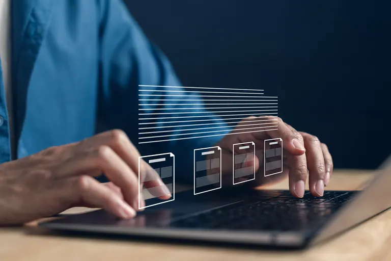 Writer organizing digital content on a laptop