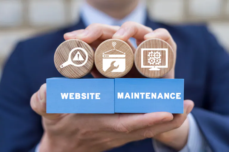 Website maintenance symbols displayed on wooden blocks