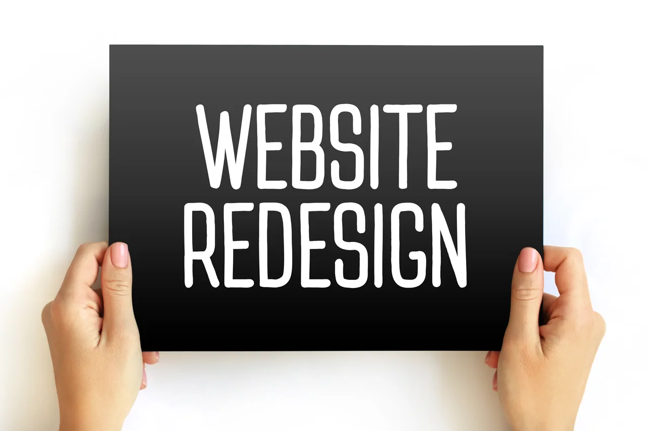 Website redesign message displayed in a workspace